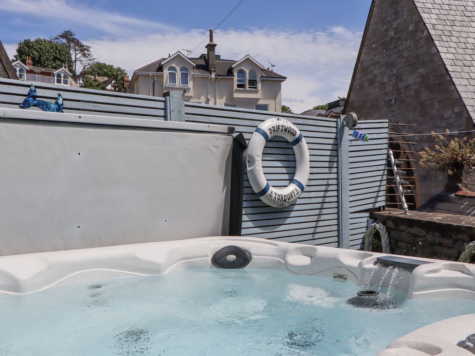 A hot tub with a lifebuoy at Driftwood in Torquay