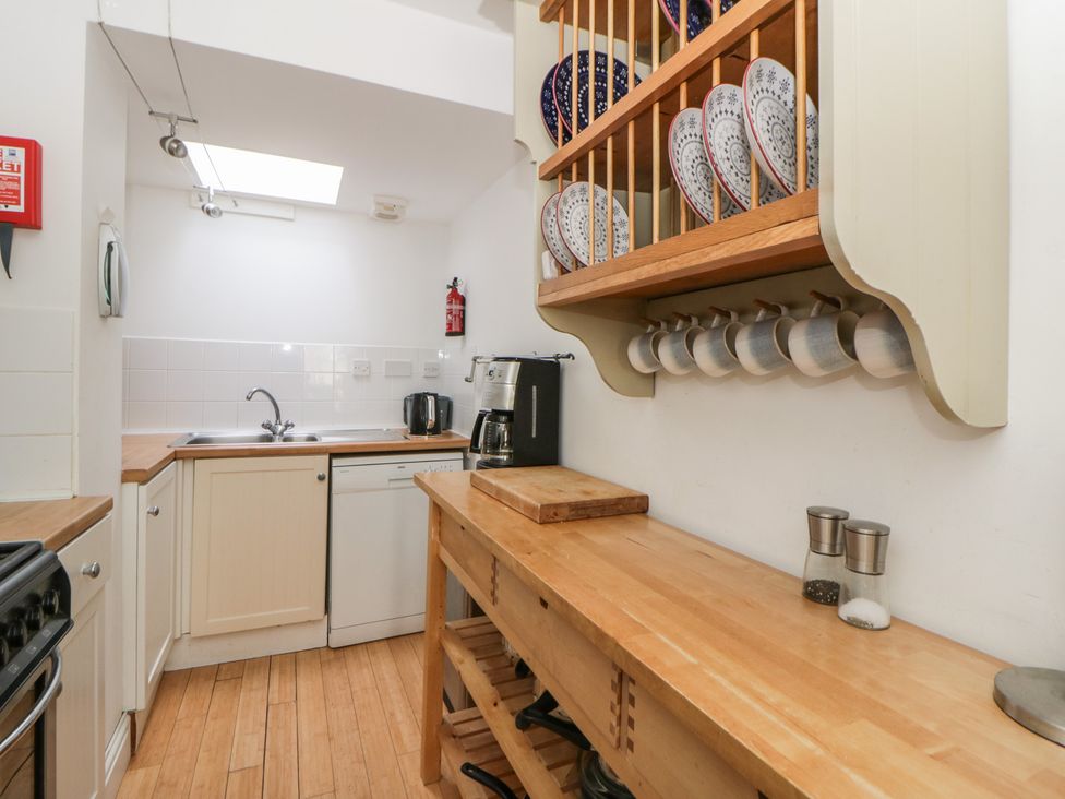 A kitchen with cabinets and utensils at Awen Ingli Newport, Pembrokeshire