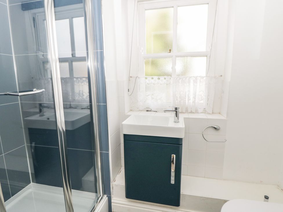 A bathroom with a sink and shower at Awen Ingli in Newport, Pembrokeshire