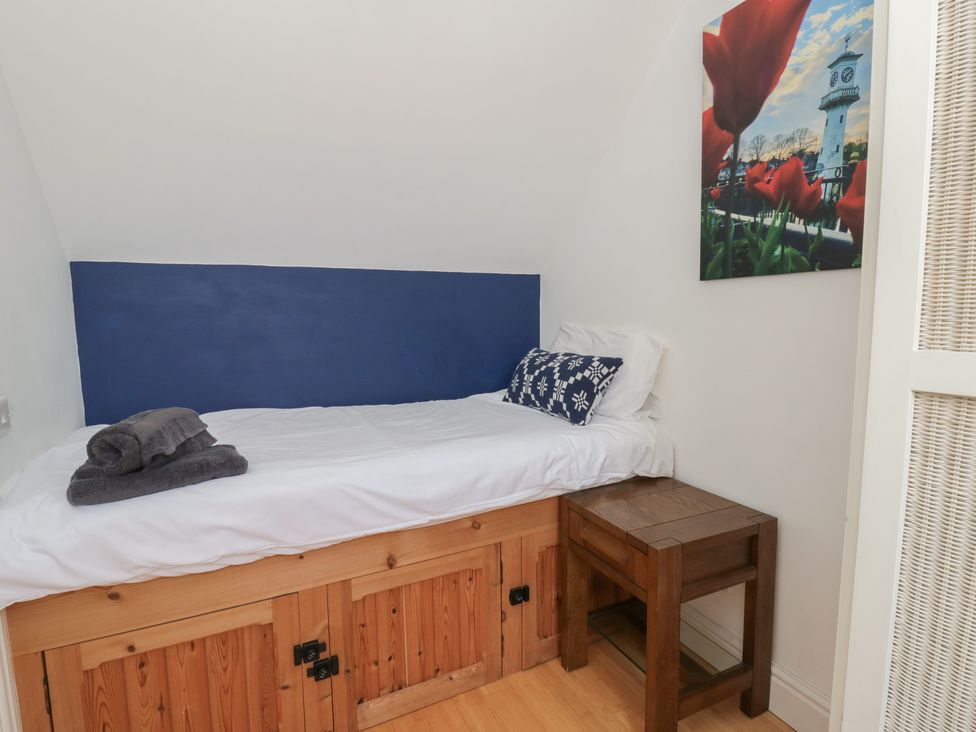 A bedroom with a bed and bedside table at Awen Ingli in Newport, Pembrokeshire