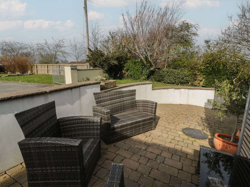A garden with seating and plants at Awen Ingli in Newport, Pembrokeshire
