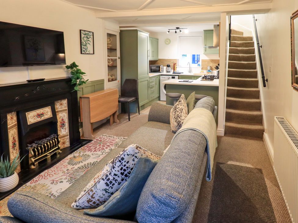 A living room with a sofa and television at 21 Entry Lane in Kendal