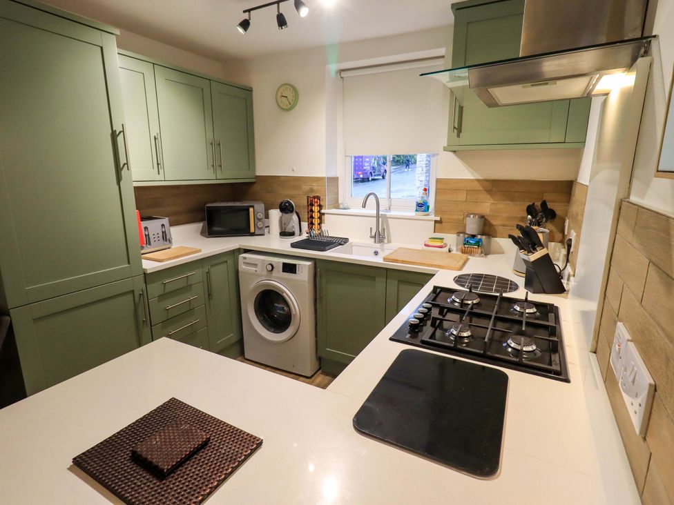 A kitchen with green cabinets and appliances at 21 Entry Lane Kendal