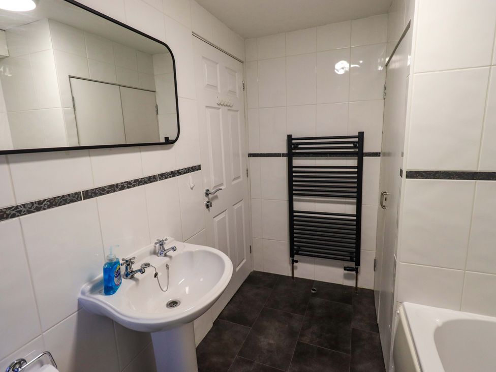 A bathroom with a sink and towel radiator at 21 Entry Lane in Kendal