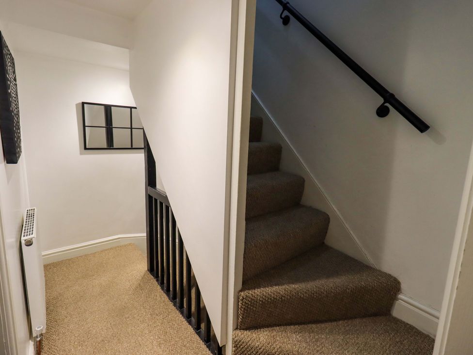 A stairway with a mirror and staircase at 21 Entry Lane Kendal