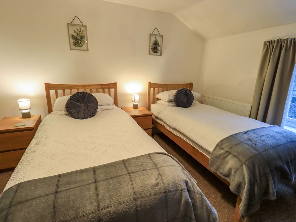 A bedroom with two beds and nightstands at 21 Entry Lane Kendal