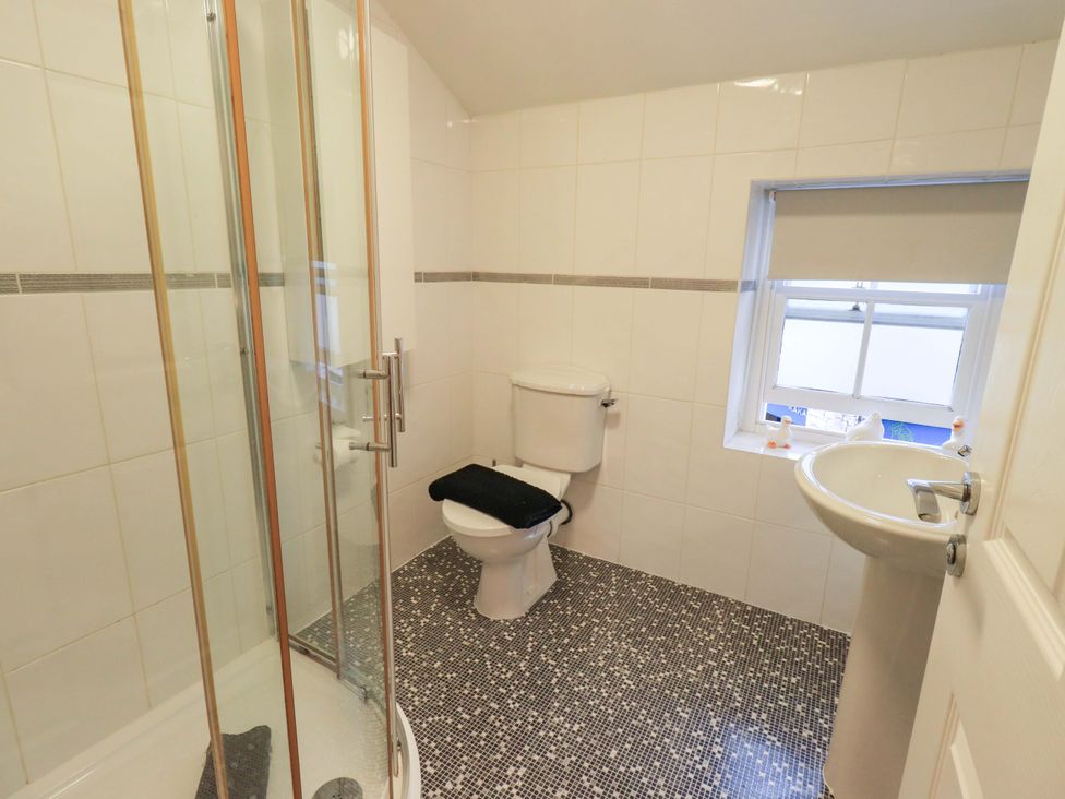 A bathroom with a shower, toilet and sink at 21 Entry Lane Kendal