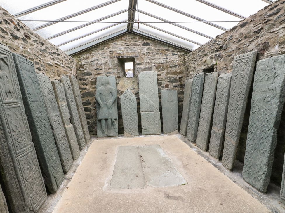 A room displaying standing stones and inscribed slabs at Smithy House in Kilmartin