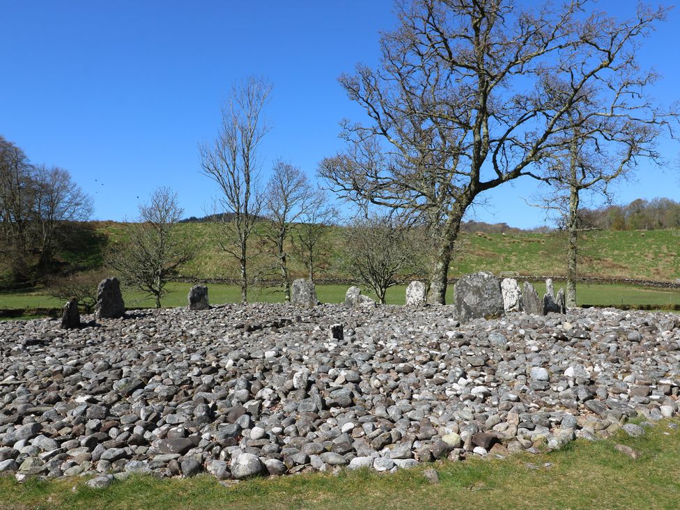 A stone circle surrounded by trees at Smithy House in Kilmartin