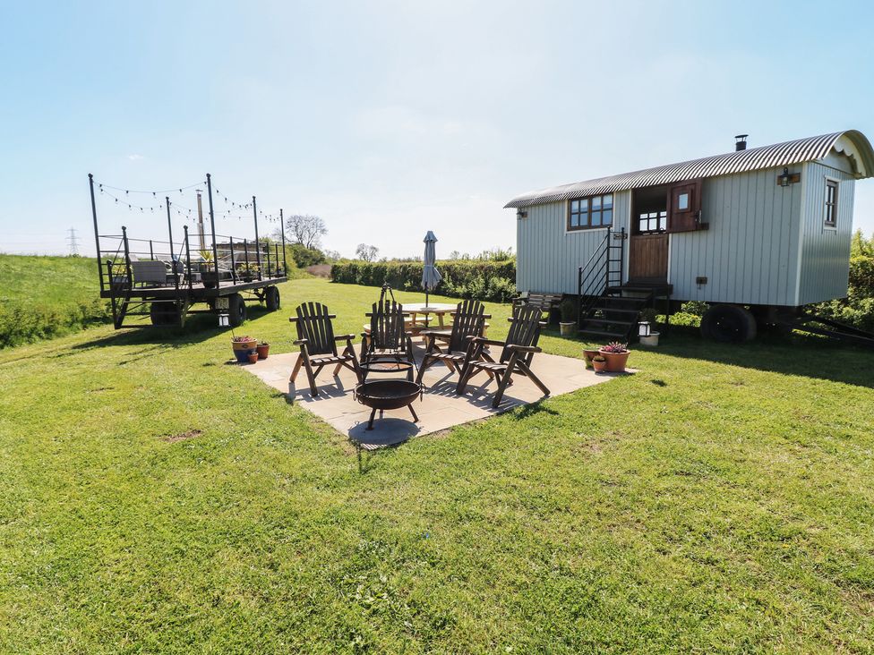 An outdoor area with chairs and a firepit at Sweet Caroline Shepherd’s Hut Low Marnham near Sutton-On-Trent
