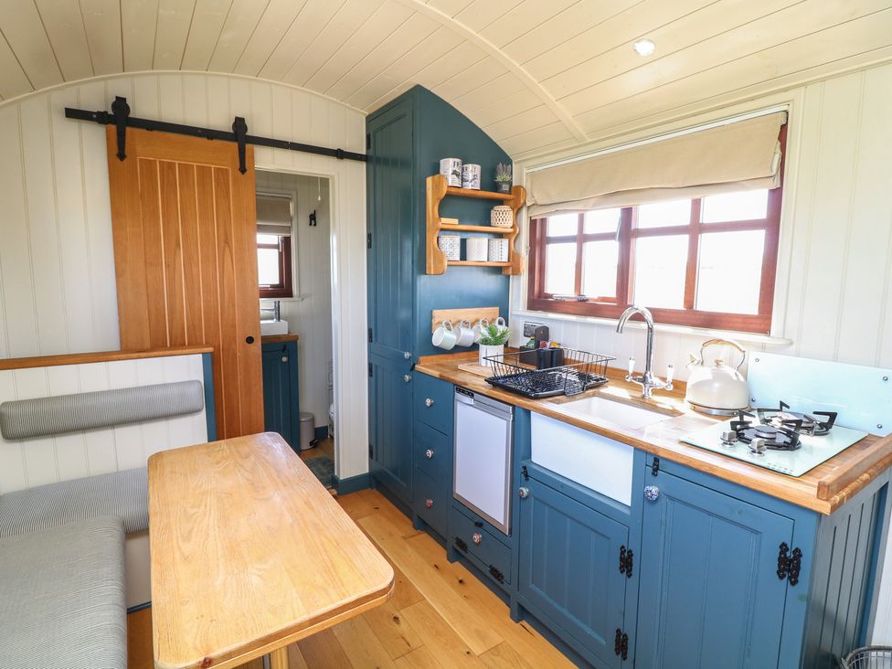 A kitchen with a sink and stove at Sweet Caroline Shepherd’s Hut Low Marnham near Sutton-On-Trent