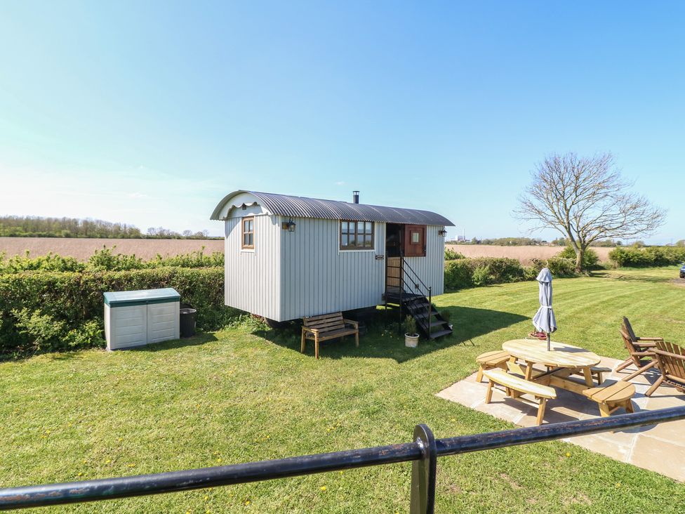 A shepherd's hut with outdoor seating at Sweet Caroline Shepherd’s Hut Low Marnham near Sutton-On-Trent