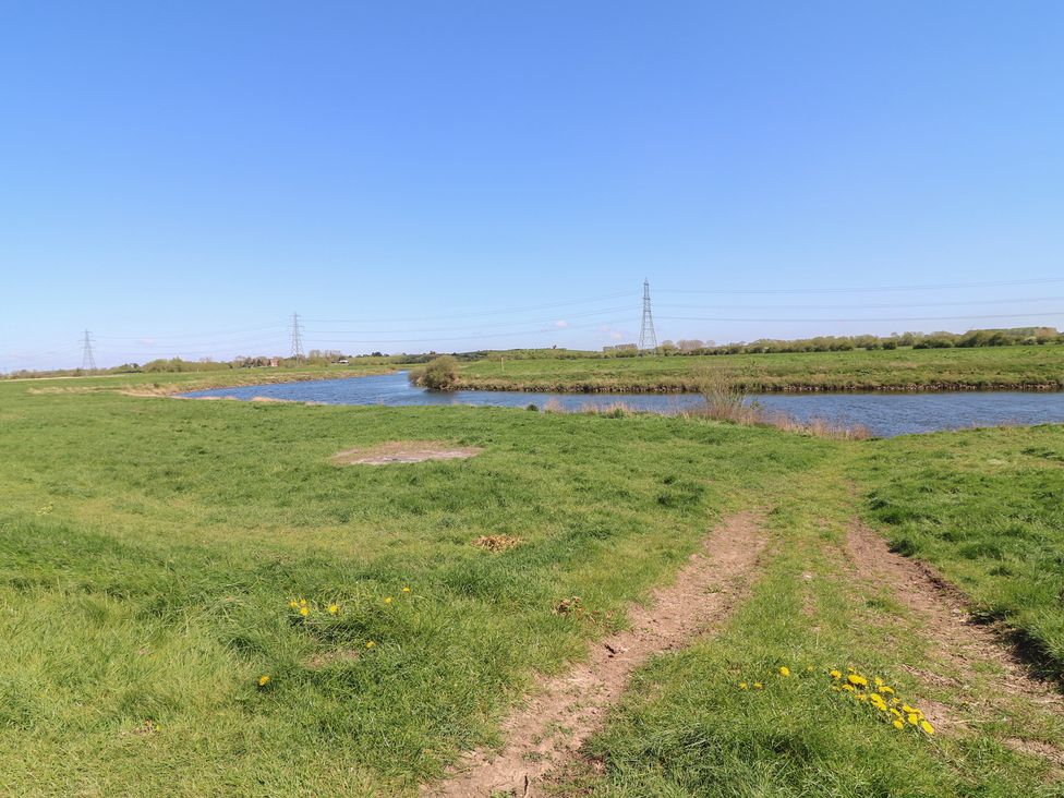 A river with grass and a path at Sweet Caroline Shepherd’s Hut in Low Marnham near Sutton-On-Trent