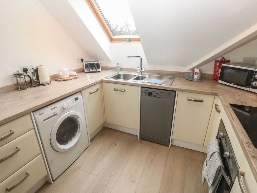 A kitchen with appliances and a sink at Upper Deck in Truro
