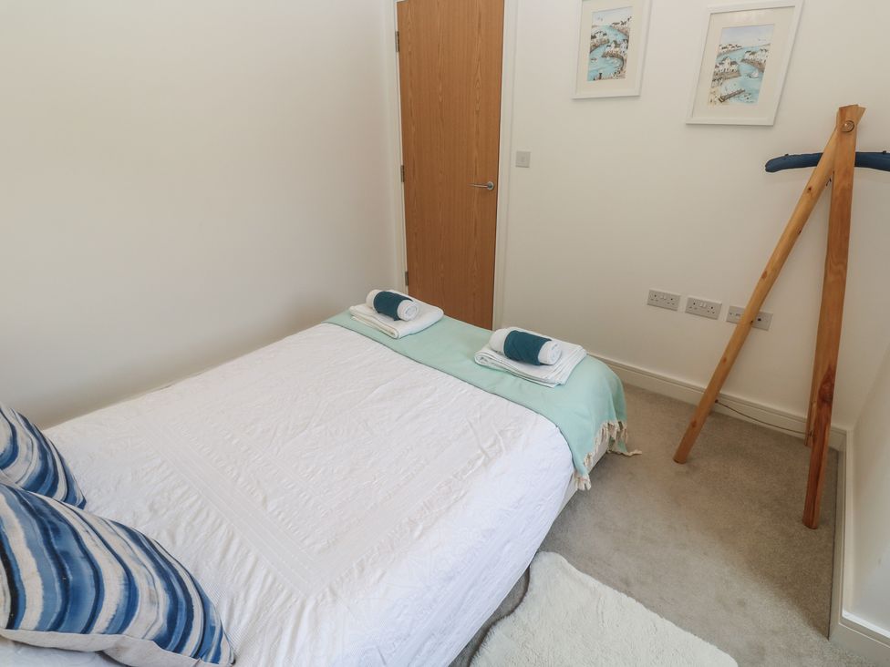 A bedroom with a bed and pillows at Upper Deck in Truro