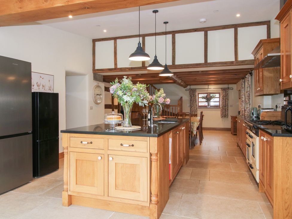 A kitchen with an island and dining area at Grove Farm Cardington near Church Stretton