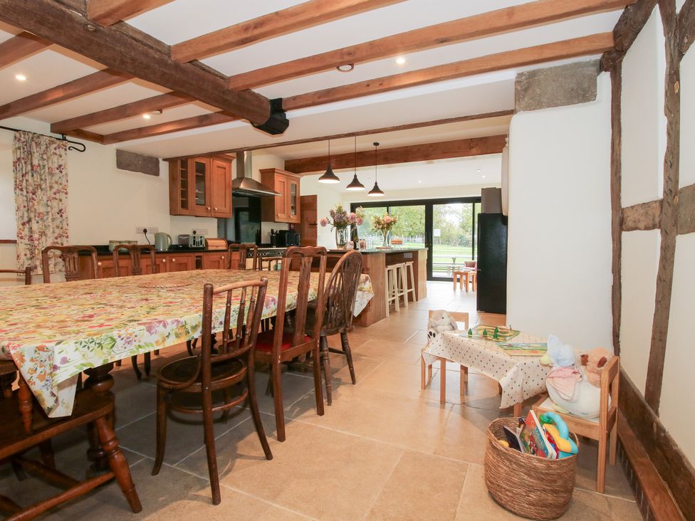 A kitchen with a dining table and chairs at Grove Farm Cardington near Church Stretton
