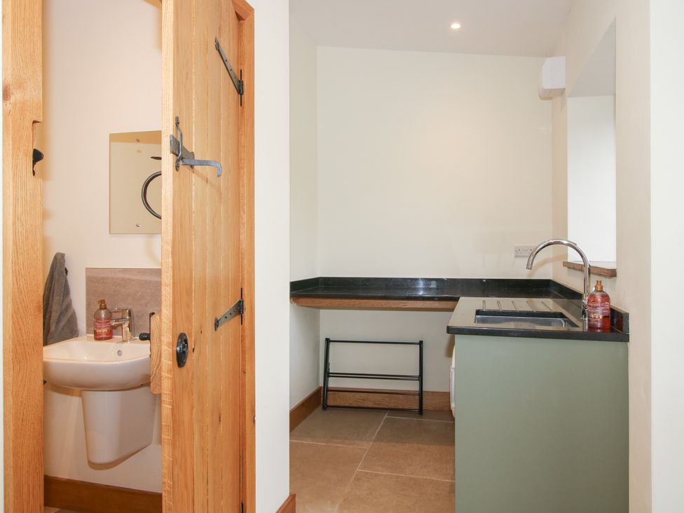 A bathroom with a toilet and sink at Grove Farm Cardington near Church Stretton