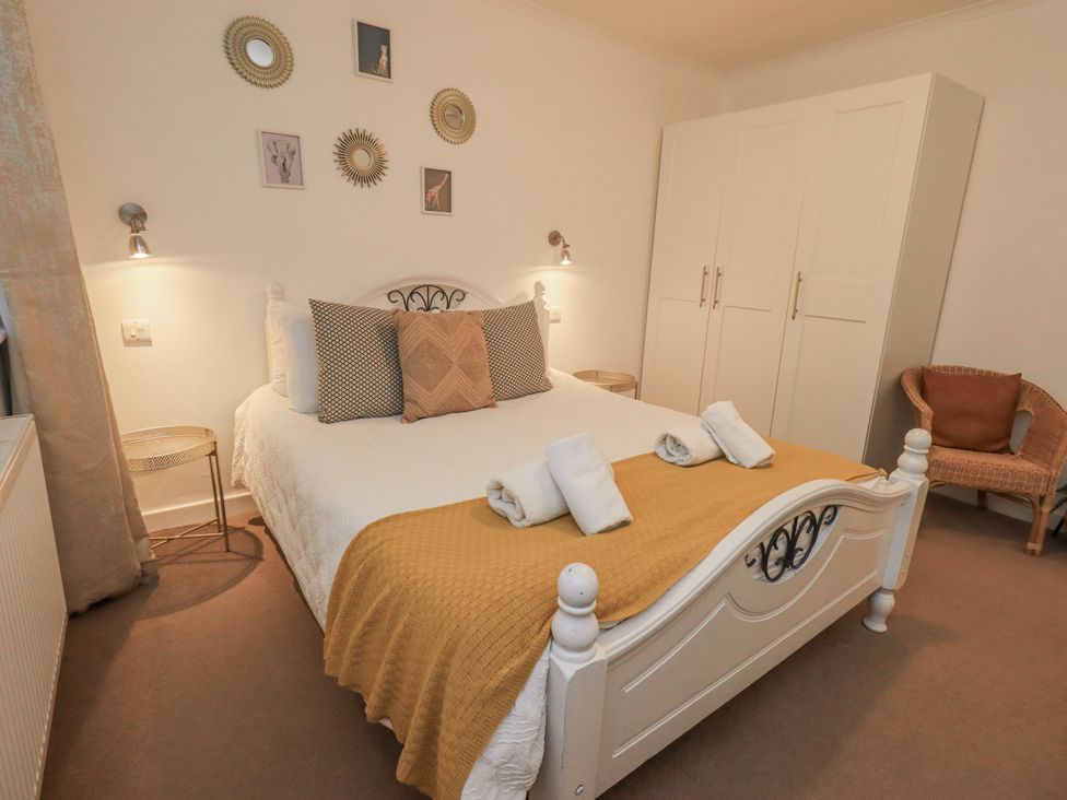A bedroom with a bed and wardrobe at 8 Beechwood Close Bowness-On-Windermere