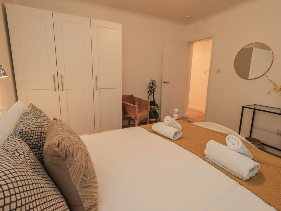 A bedroom with a bed and wardrobe at 8 Beechwood Close Bowness-On-Windermere