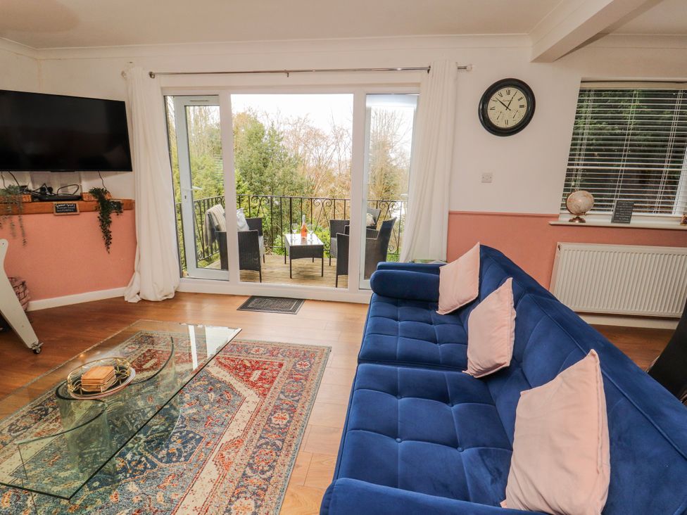 A living room with a sofa and television at Lake View in Bowness-On-Windermere