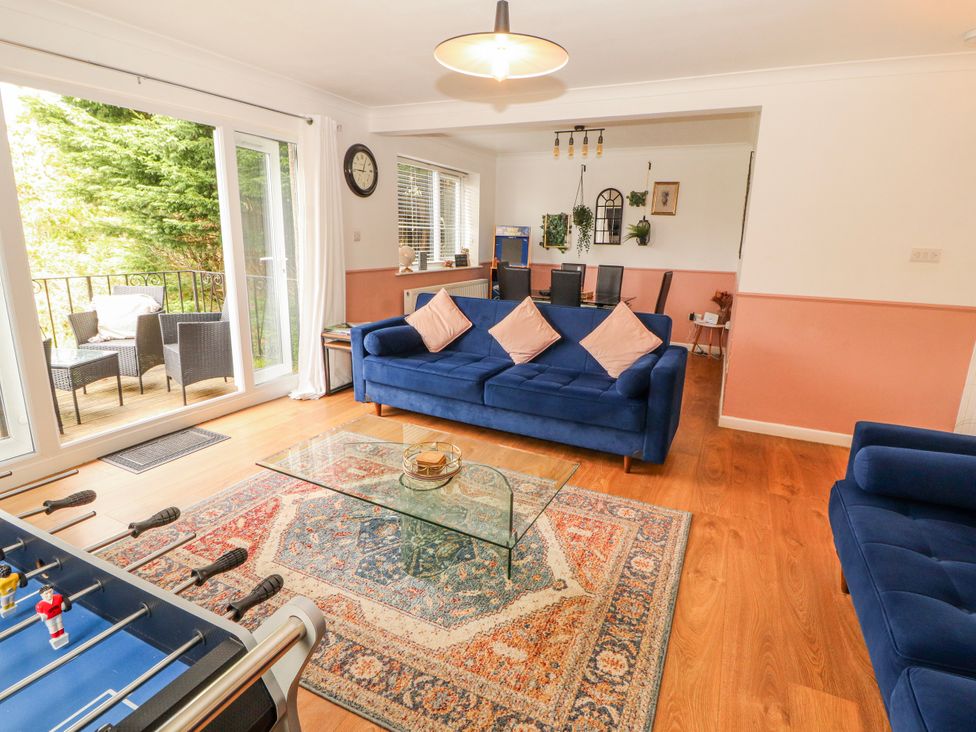 A living room with a coffee table and foosball table at Lake View in Bowness-On-Windermere