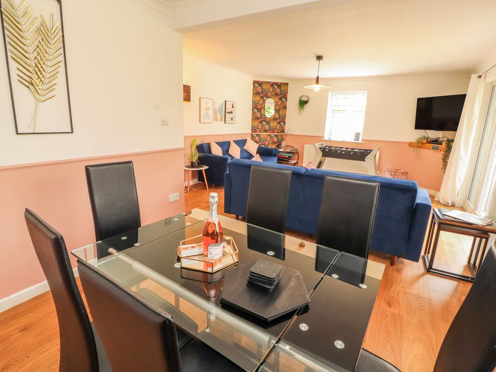 A dining room with a glass table and chairs at Lake View in Bowness-On-Windermere