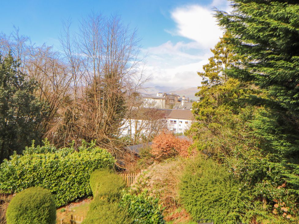 A view of trees and a building from above at Lake View in Bowness-On-Windermere