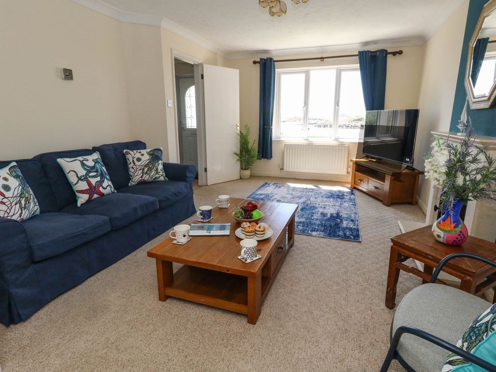 A living room with a sofa and coffee table at Cove Cottage in Weymouth