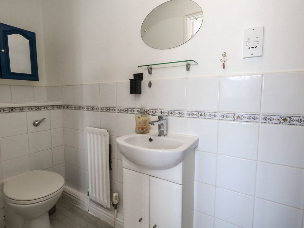 A bathroom with a sink and toilet at Cove Cottage in Weymouth