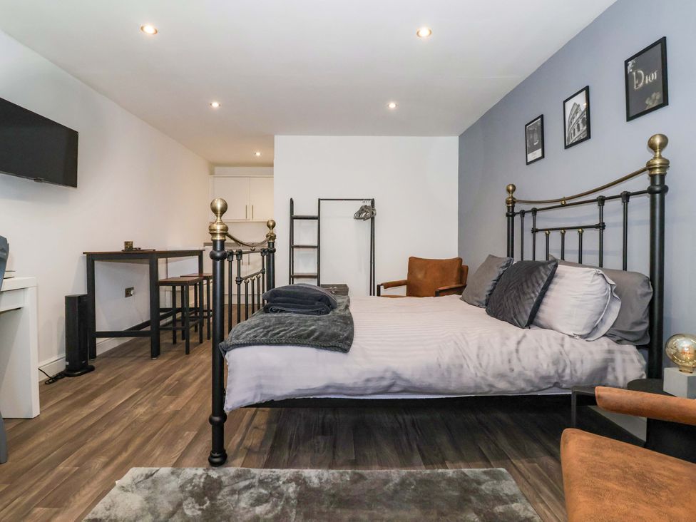 A bedroom with a bed and desk at Chalet 2 East Heslerton near Sherburn