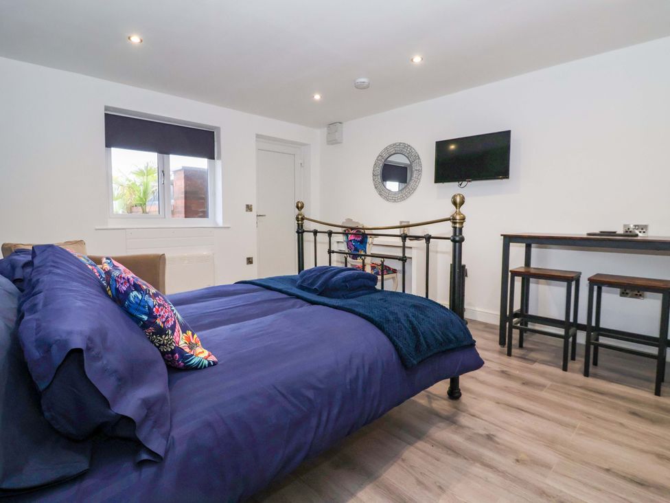 A bedroom with a bed and a television at Chalet 3 in Sherburn