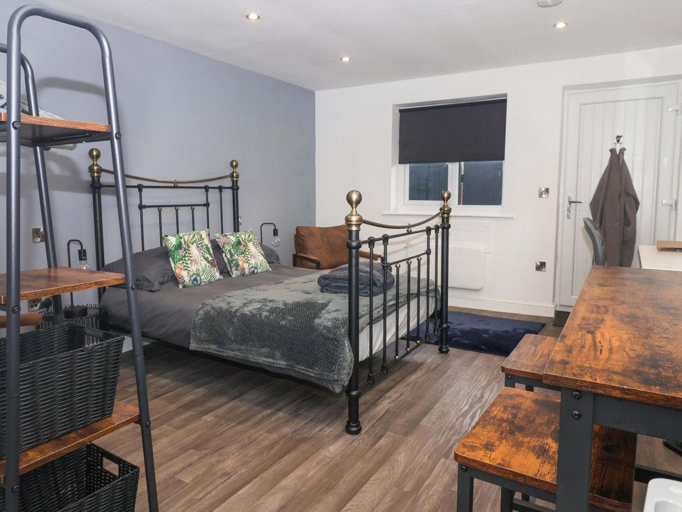 A bedroom with a bed and desk at Chalet 4 in East Heslerton near Sherburn