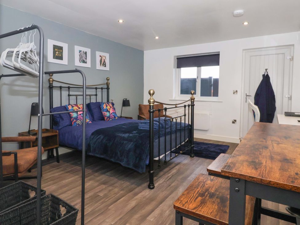 A bedroom with a bed and a desk at Chalet 5 in Sherburn