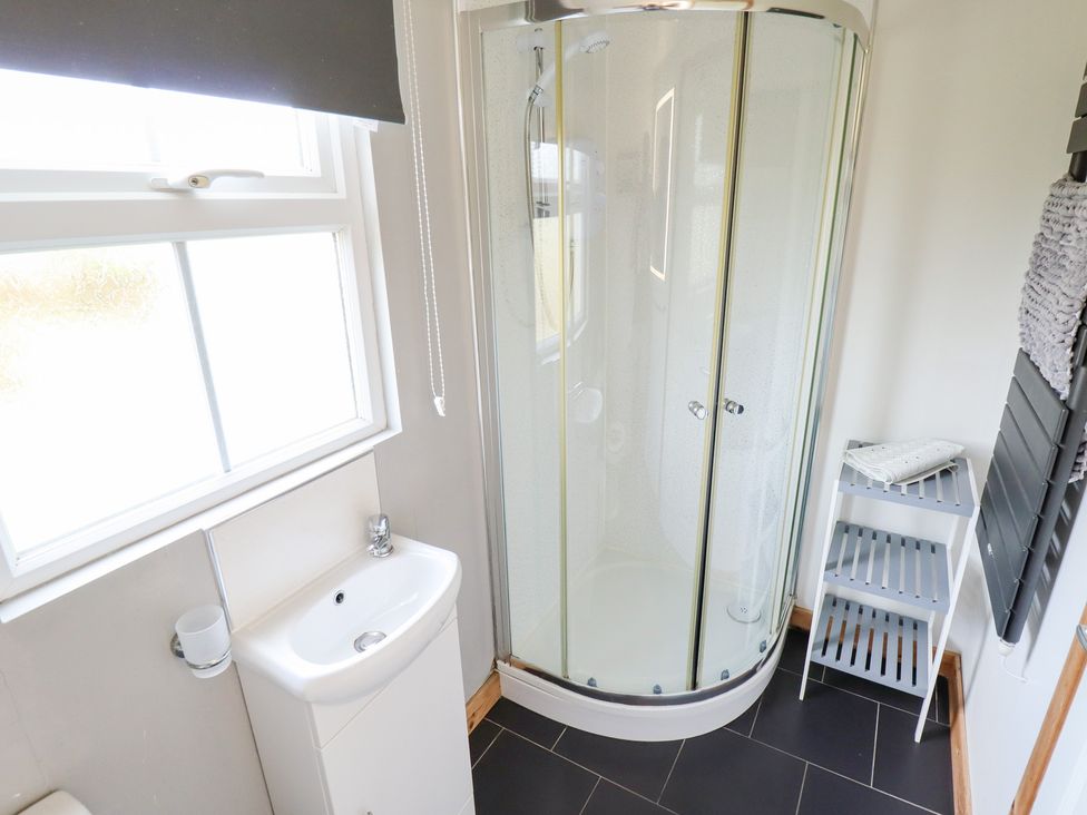 A bathroom with a shower and sink at Angel's Retreat in Huttoft