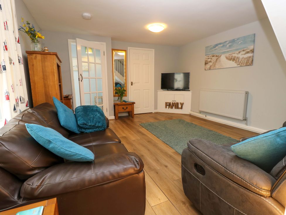 A living room with a sofa and television at Willow Cottage in Ventnor