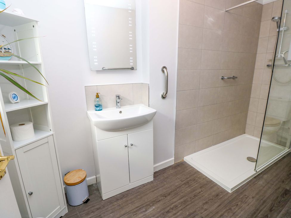A bathroom with a sink and shower at Willow Cottage in Ventnor