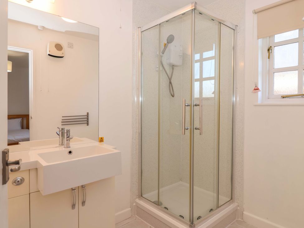 A bathroom with a shower and sink at Bracken Cottage St Tudy