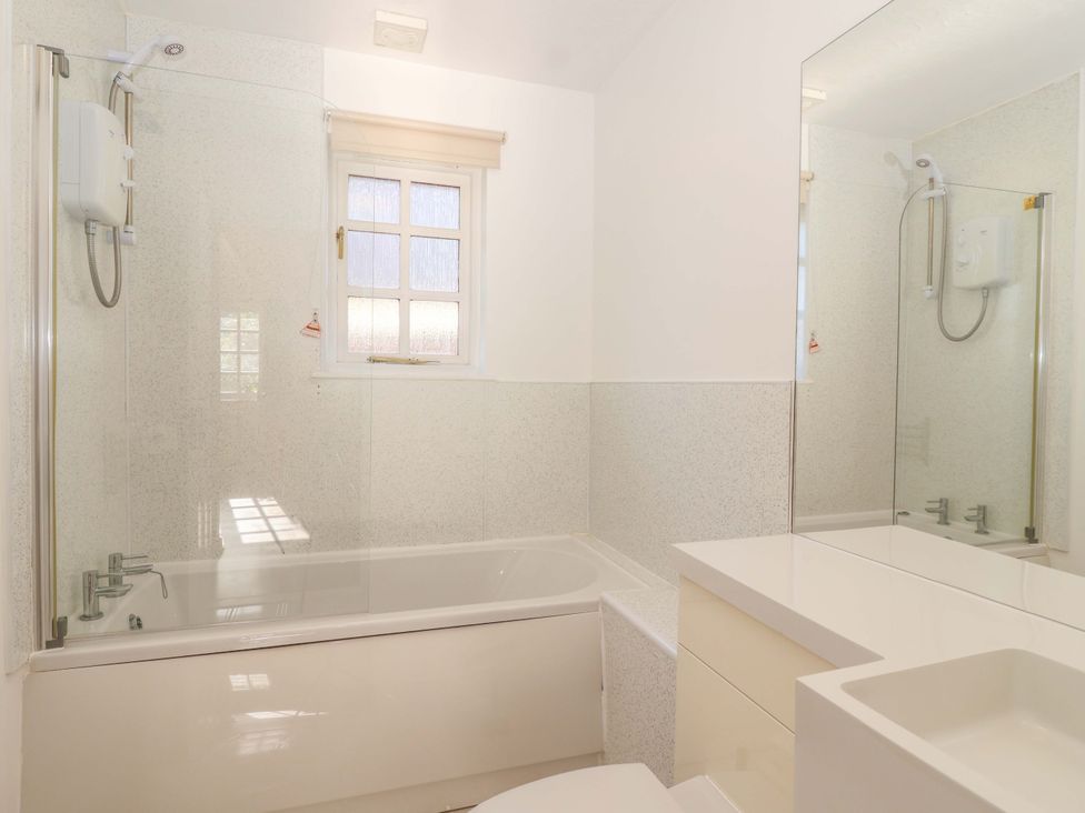 A bathroom with a bathtub and sink at Bracken Cottage St Tudy