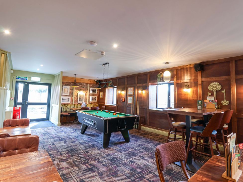 A snug with a pool table and seating area at Bracken Cottage St Tudy