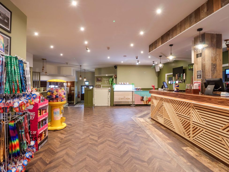 A lobby with a reception desk and a gumball machine at Bracken Cottage St Tudy