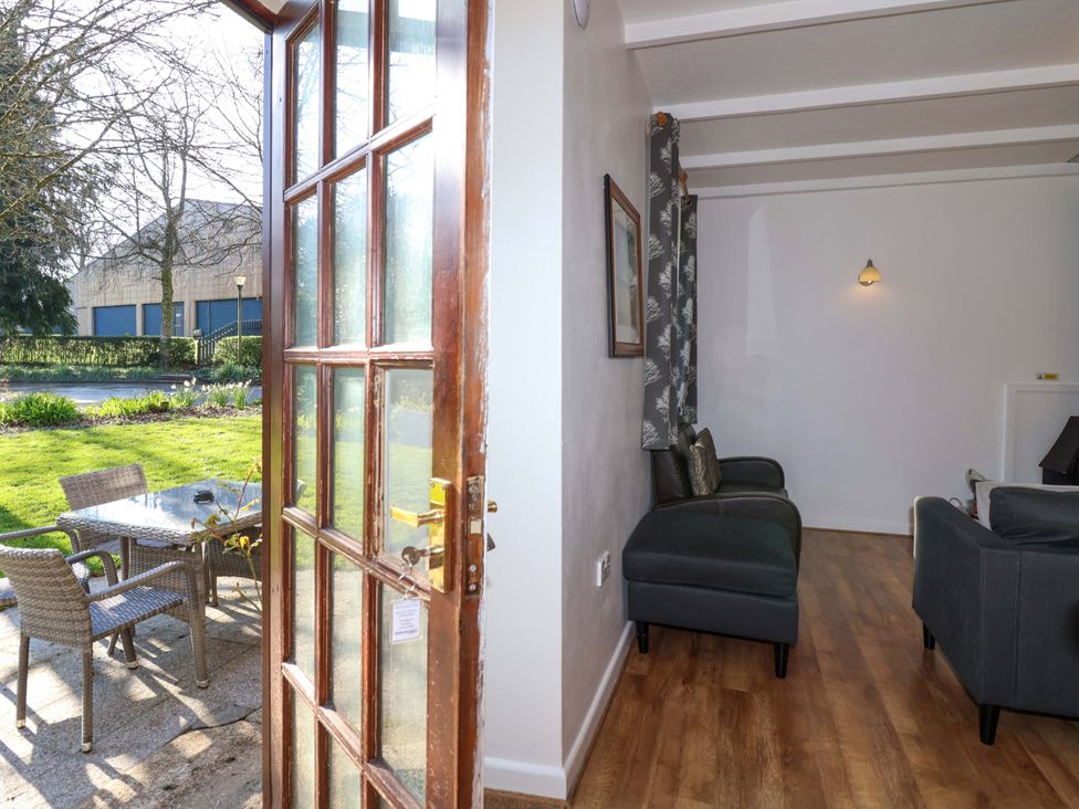 A living room with sofas and a view of the garden at Roughtor Cottage St Tudy