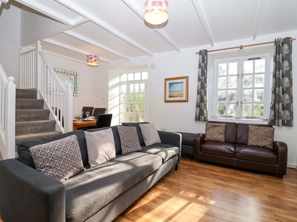 A living room with sofas and a dining table at Roughtor Cottage St Tudy