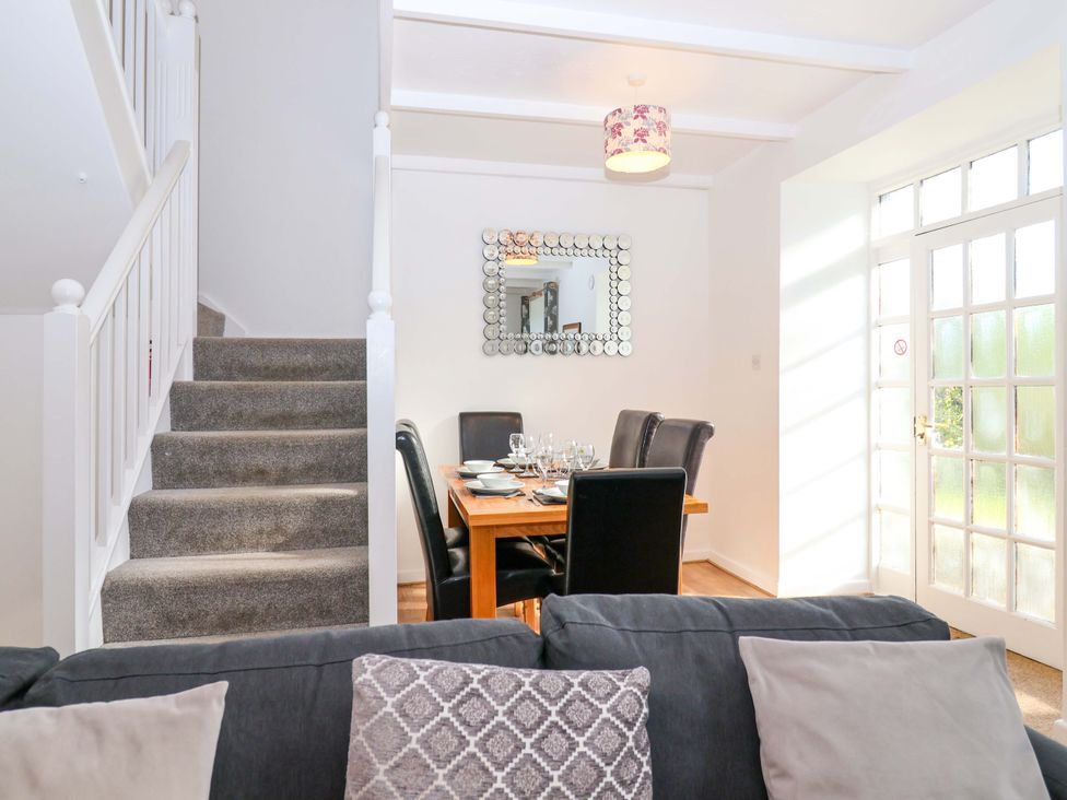 A dining room with a table and chairs at Roughtor Cottage St Tudy