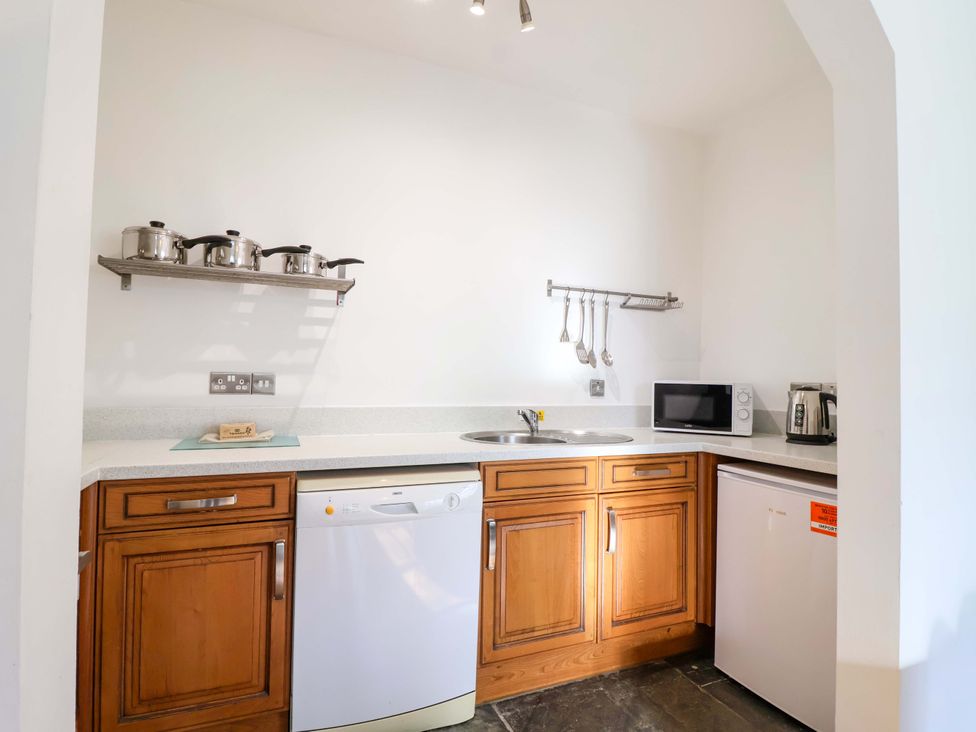A kitchen with appliances and utensils at Roughtor Cottage St Tudy
