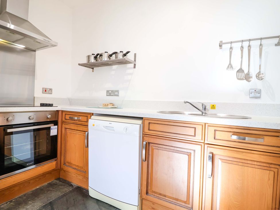 A kitchen with appliances and utensils at Roughtor Cottage in St Tudy