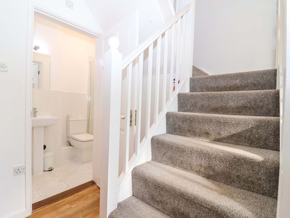 A landing area with stairs and access to a bathroom at Roughtor Cottage St Tudy