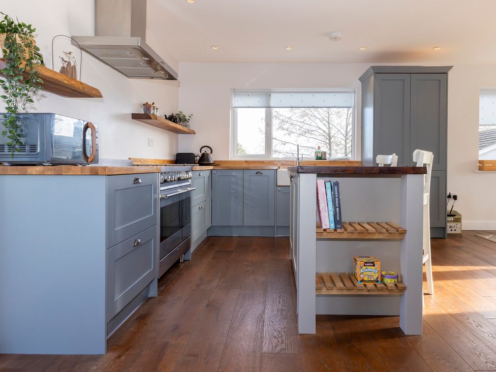 A kitchen with cabinets and an island at 38 Venn Park in Stoke Fleming