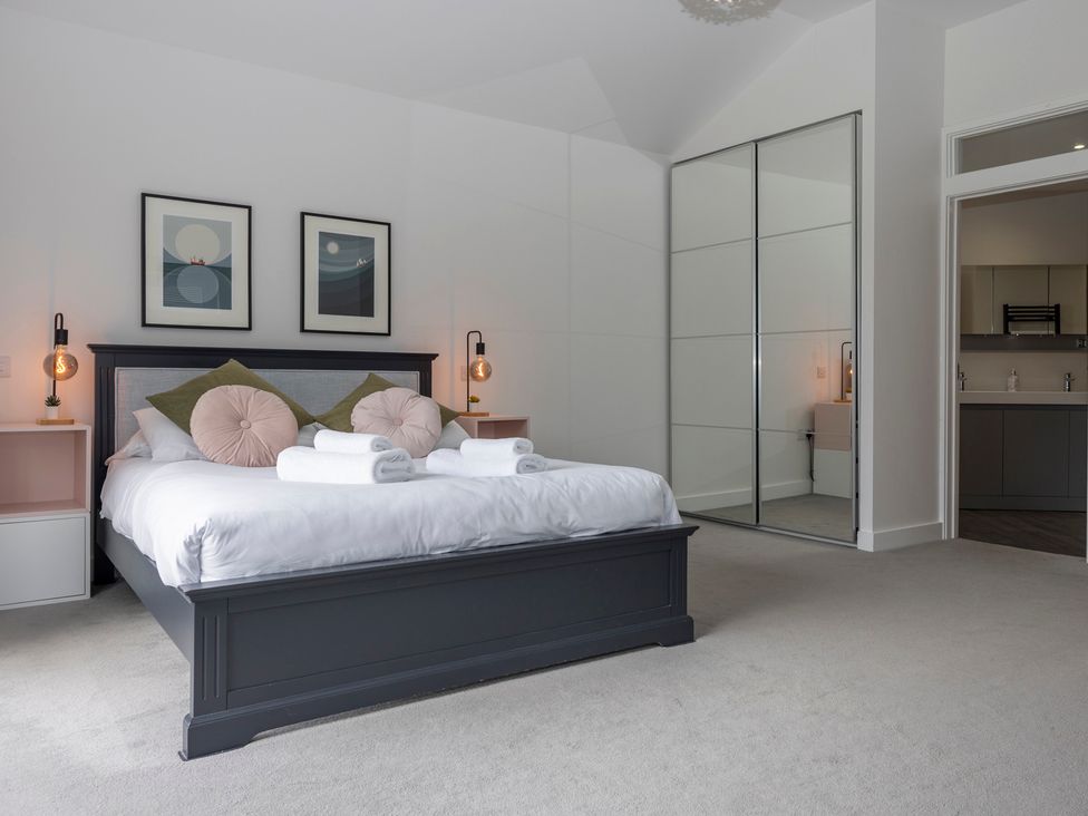 A bedroom with a bed and bedside tables at 38 Venn Park Stoke Fleming