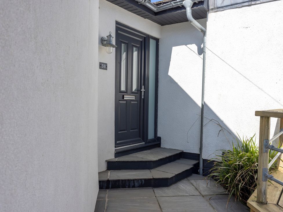 An entrance with steps leading to a door at 38 Venn Park in Stoke Fleming